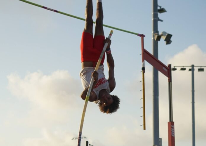 a person doing a high jump on a pole