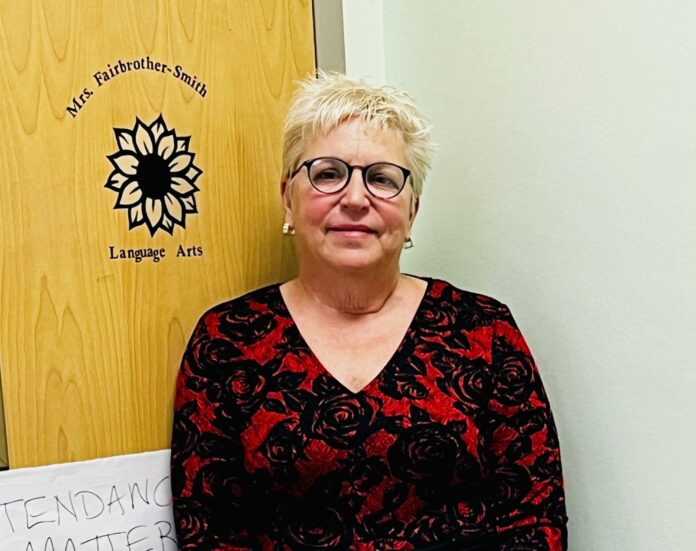 FullSizeR a woman standing in front of a sign