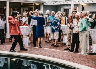 a group of people standing around a pool