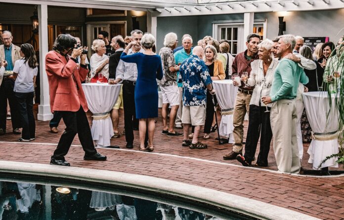 a group of people standing around a pool