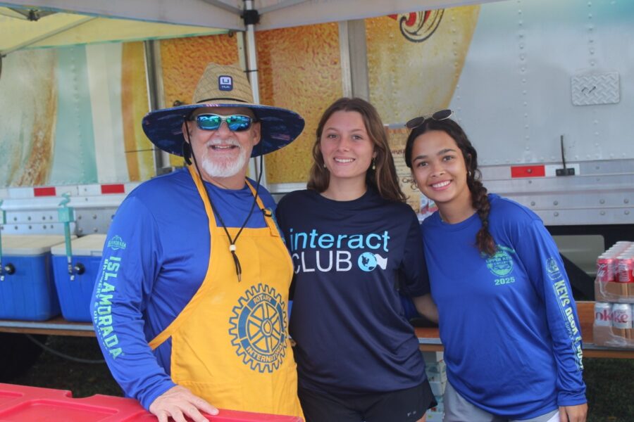 a group of people standing next to each other under a tent