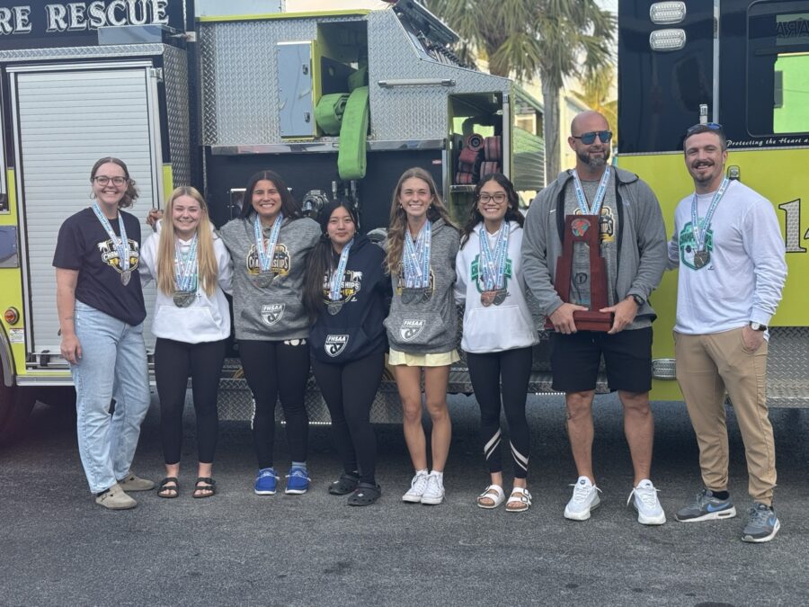 a group of people standing in front of a fire truck