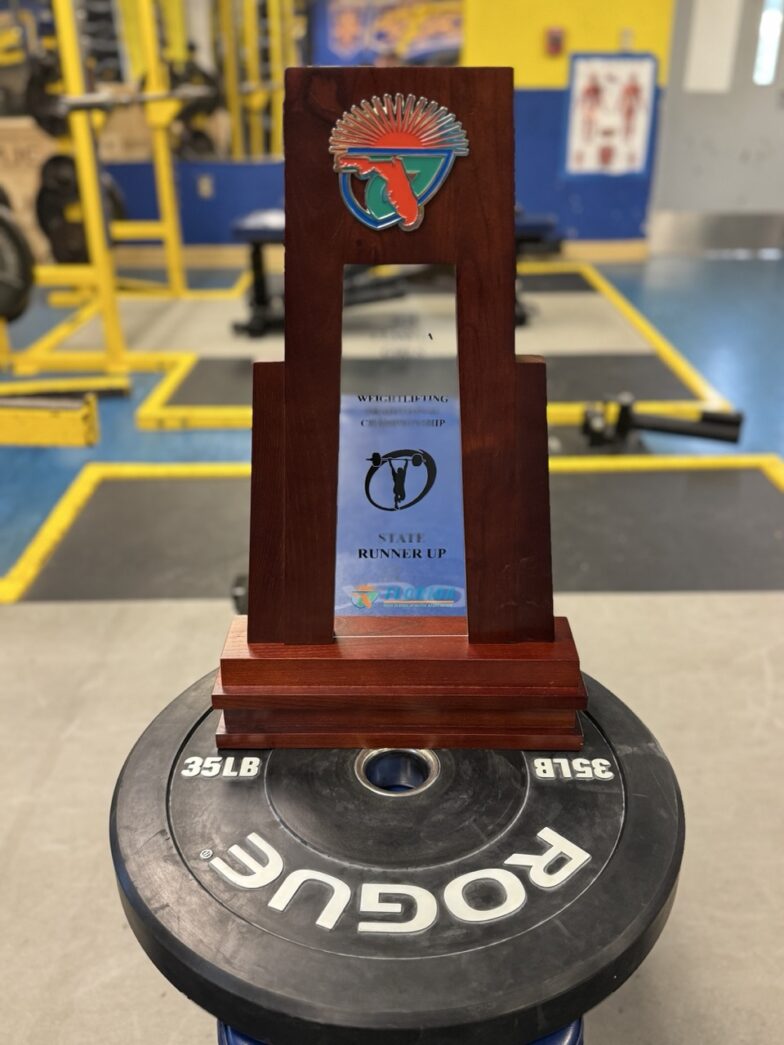 a wooden trophy sitting on top of a table