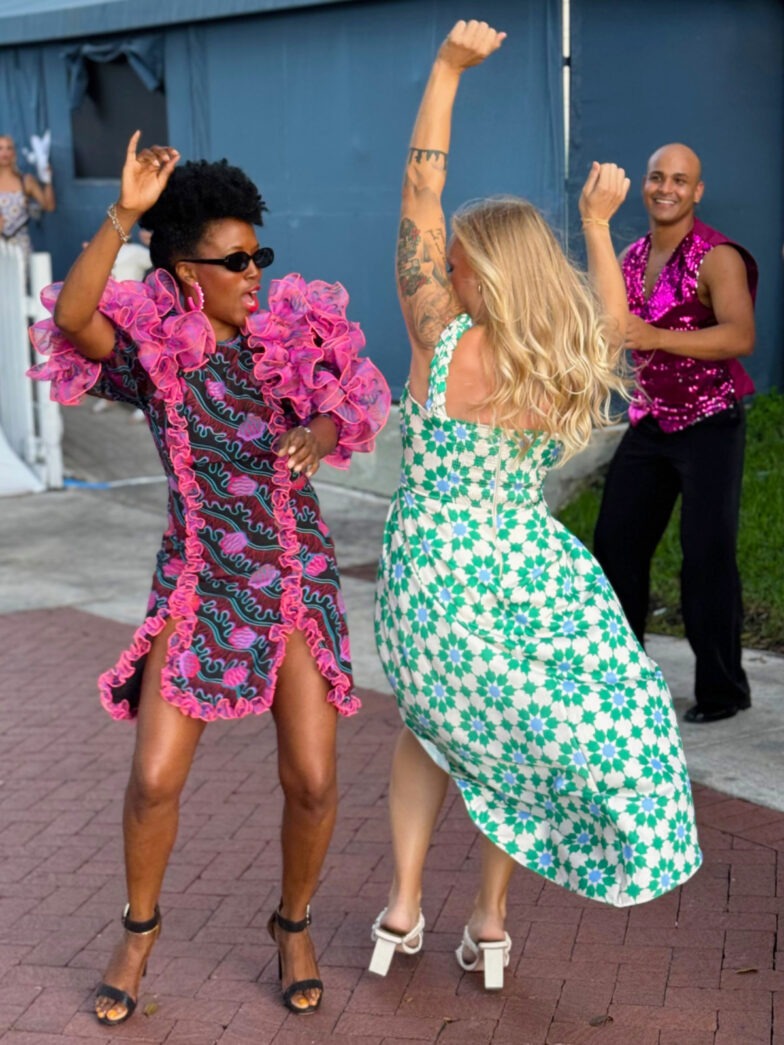 a couple of people that are dancing on a sidewalk