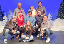 a group of people posing for a picture on a stage