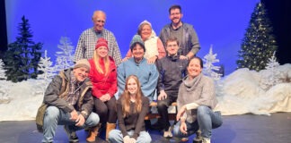 a group of people posing for a picture on a stage