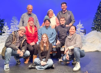 a group of people posing for a picture on a stage