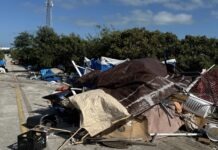 a pile of trash sitting on the side of a road