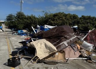 a pile of trash sitting on the side of a road