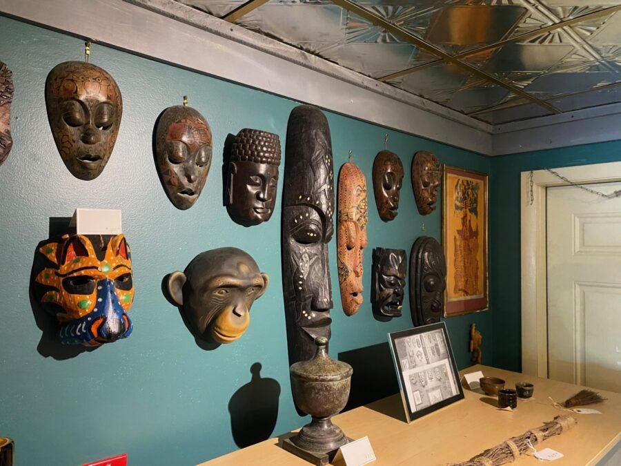 a group of african masks mounted on a wall