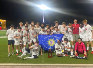 a group of men standing on top of a soccer field