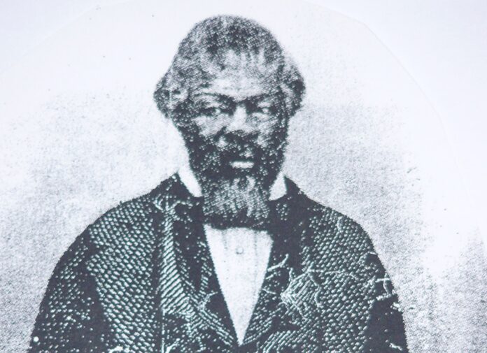 a black and white photo of a man with a beard