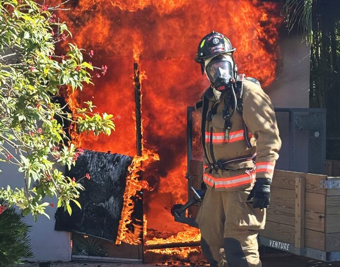 a firefighter standing in front of a fire