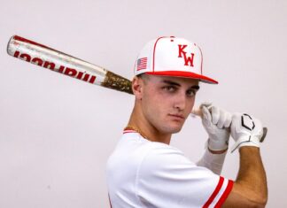 a man in a baseball uniform holding a bat