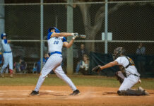 a baseball player swinging a bat at a ball