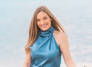 a woman in a blue dress holding a rock