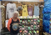 a woman standing in front of a display of merchandise