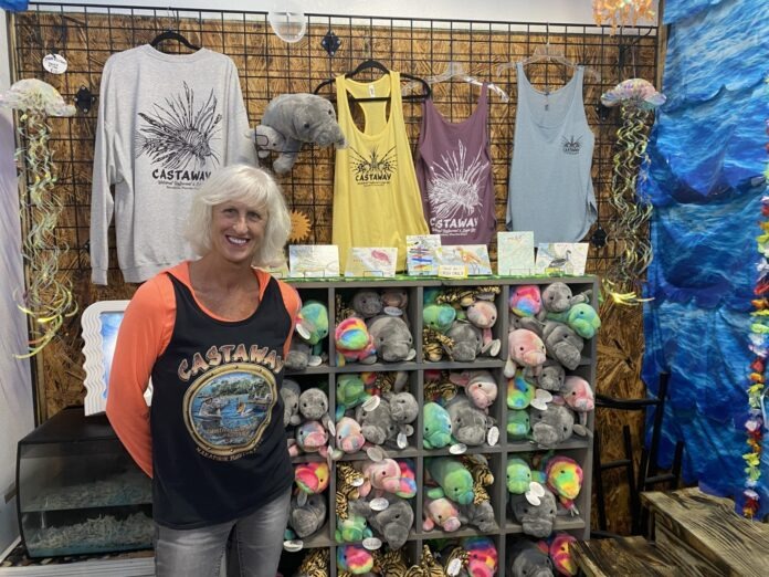 a woman standing in front of a display of merchandise