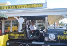 a man standing inside of a small train