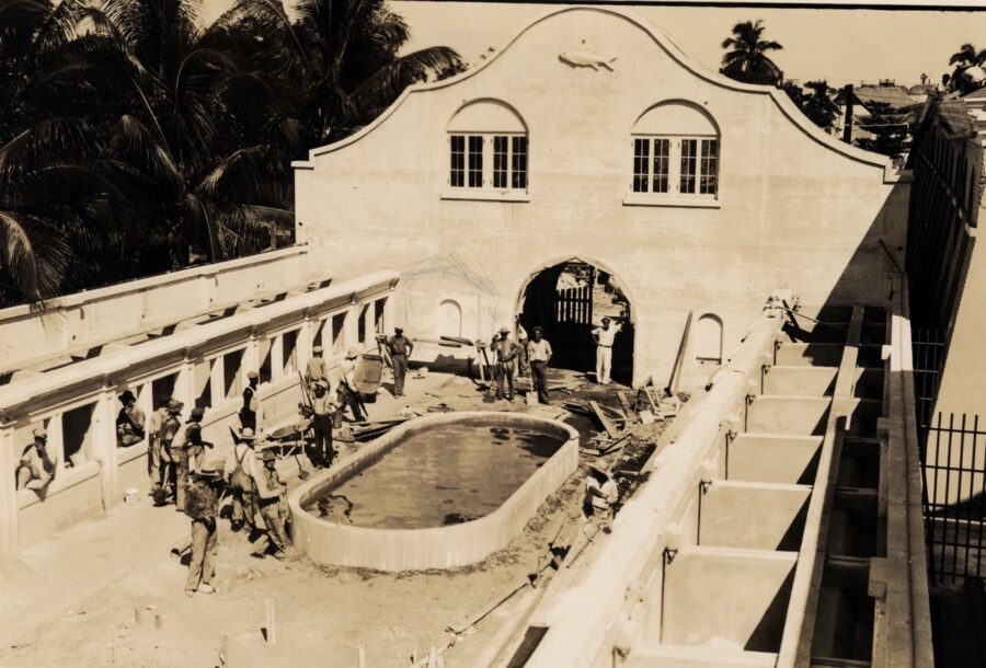 a black and white photo of a building with a fountain