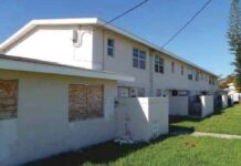 a row of houses with boarded up windows