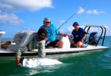 a couple of people on a boat with a fish