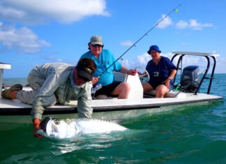 a couple of people on a boat with a fish