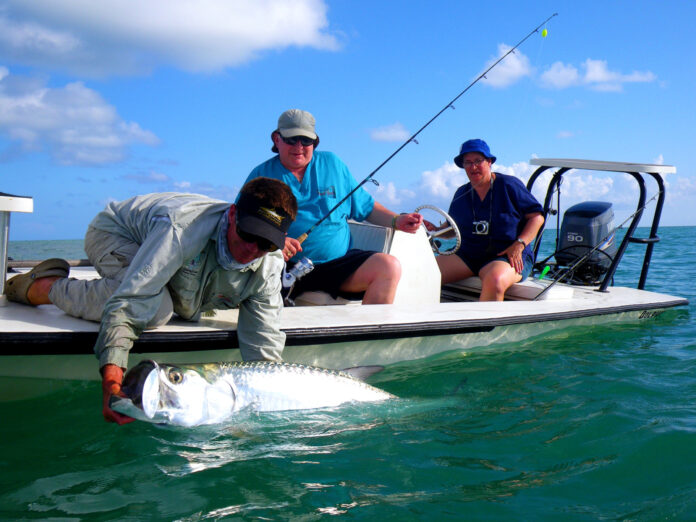 a couple of people on a boat with a fish