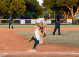 a baseball player running to first base during a game