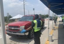 a police officer standing next to a red truck