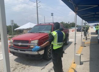 a police officer standing next to a red truck