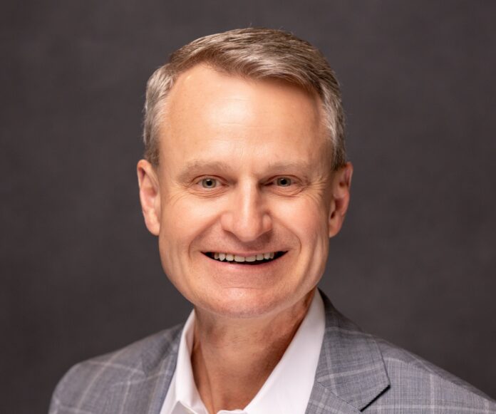 a man in a suit smiling at the camera