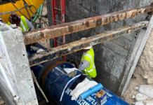 a blue fire hydrant sitting next to a building under construction