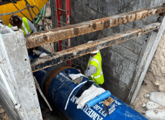 a blue fire hydrant sitting next to a building under construction
