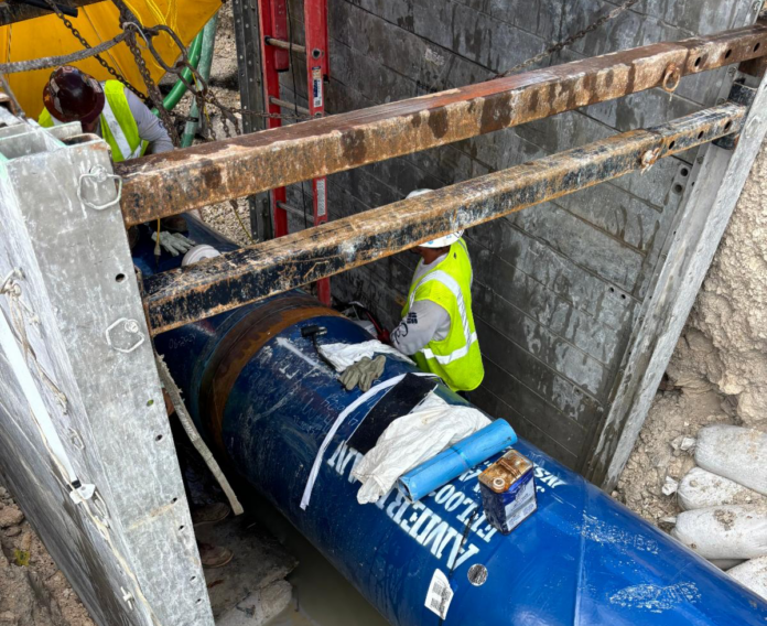 a blue fire hydrant sitting next to a building under construction