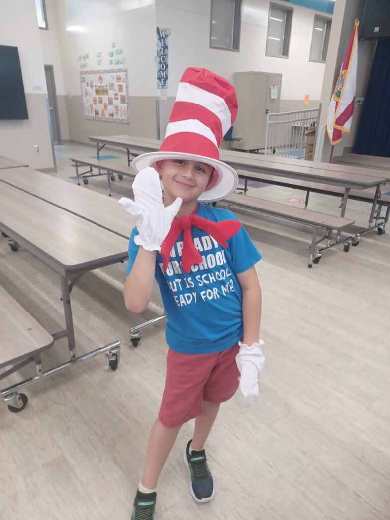 a child wearing a cat in the hat hat and gloves