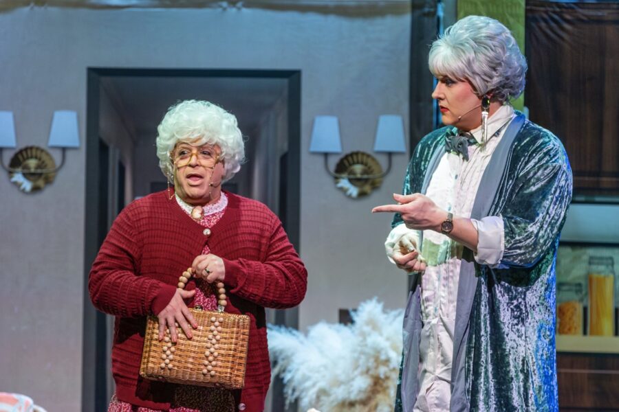 two women standing next to each other on a stage