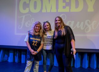 a group of women standing next to each other on a stage