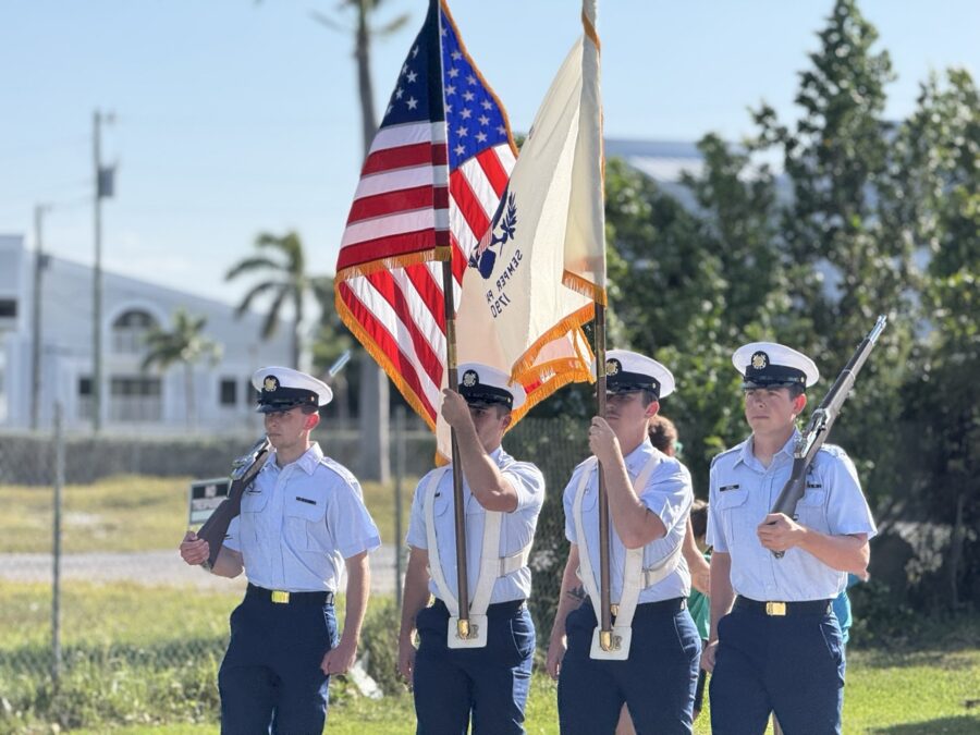 a group of uniformed men holding american flags