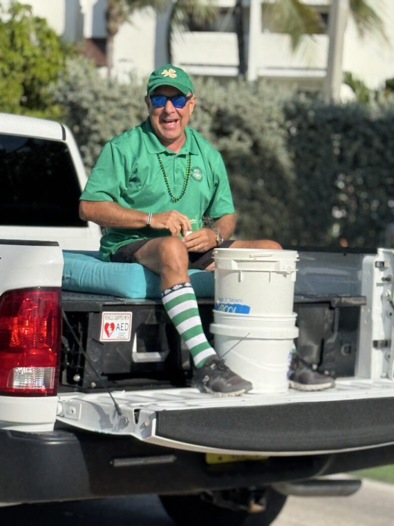 a man sitting in the back of a white truck