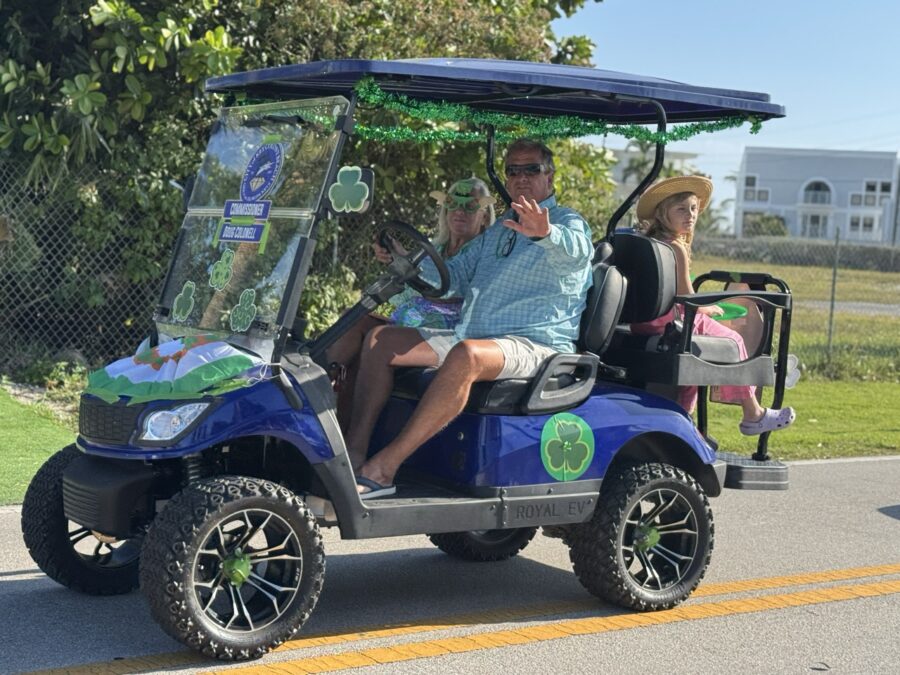 a man and a woman riding a golf cart