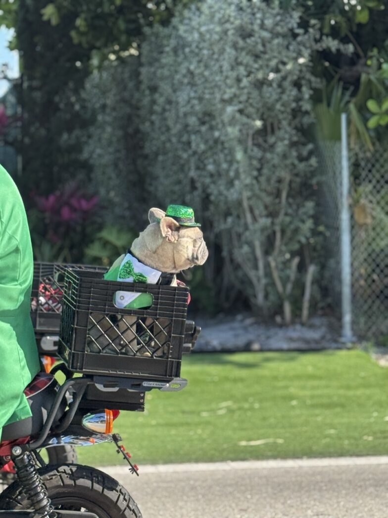 a man in a green outfit riding a motorcycle