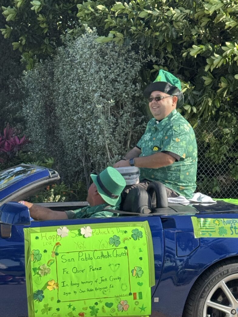 a man sitting in the back of a blue car