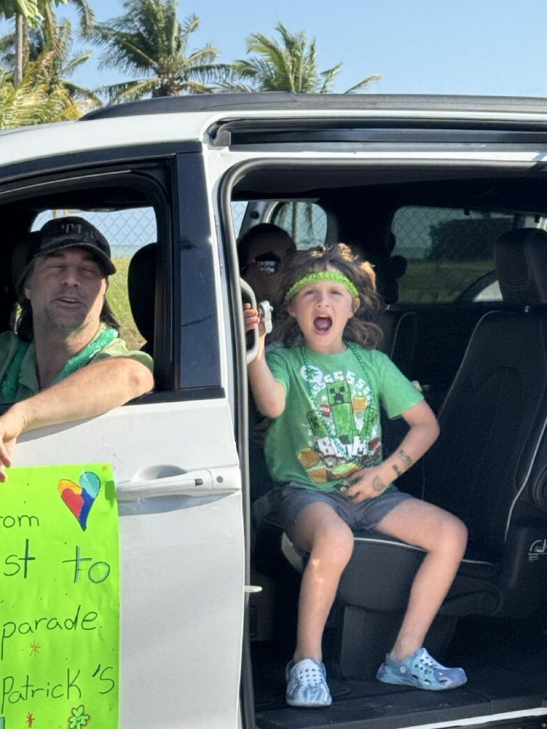 a man and a little girl sitting in the back of a van