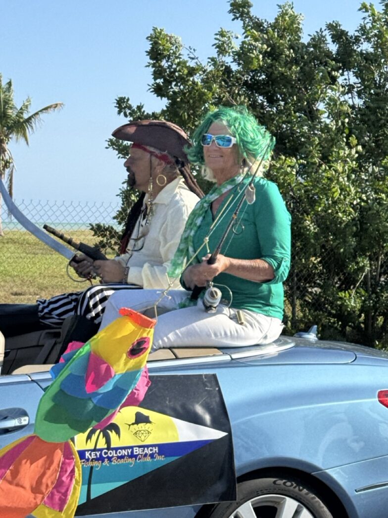 a group of people sitting on top of a car