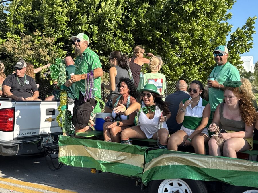 a group of people riding in the back of a truck