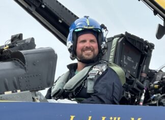 a man sitting in the cockpit of a plane