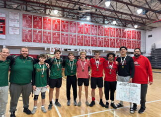 a group of young men standing on top of a basketball court