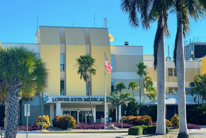 a yellow building with palm trees in front of it