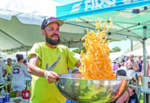 a man holding a large metal bowl of food